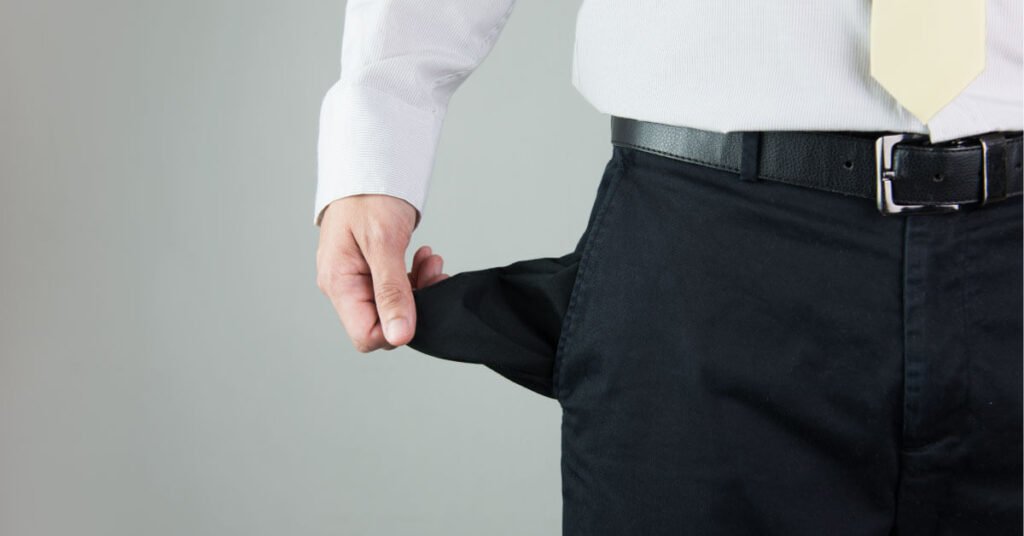 Businessman pulling out empty pocket