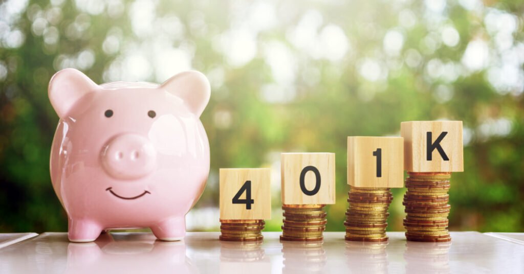 piggy bank next to coins and blocks that spell out 401k