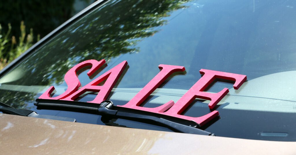 the word sale on top of car windshield