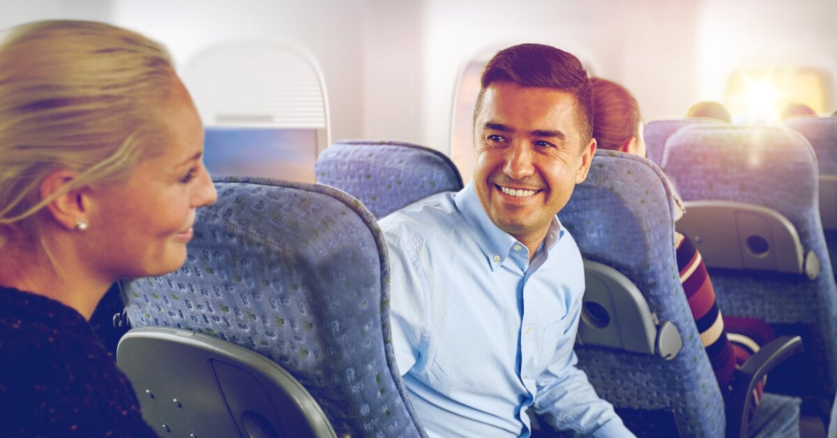 Man And Woman Smiling On Airplane