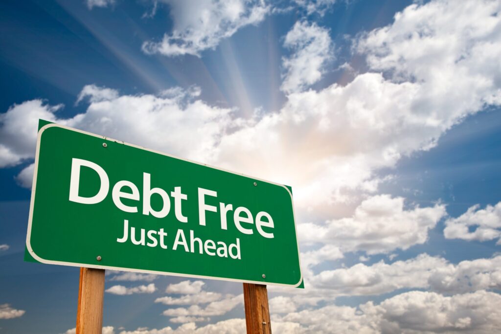 debt free just ahead green road sign