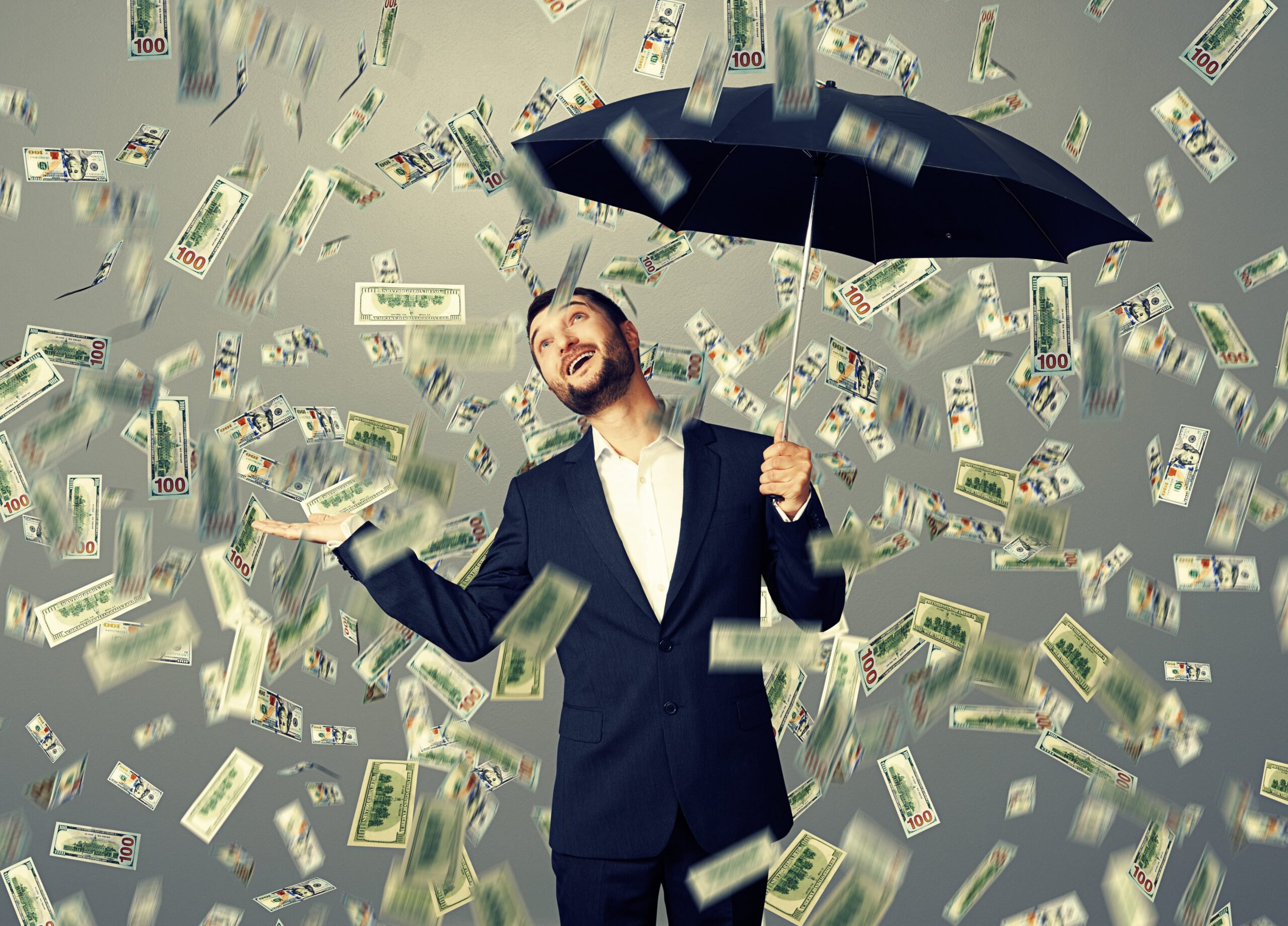 Money Raining Down On Man With Umbrella