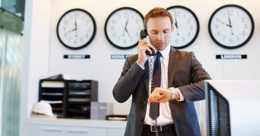 financial advisor looking at watch while on the phone