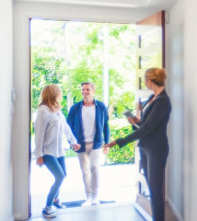 colorado real estate agent welcoming couple into home