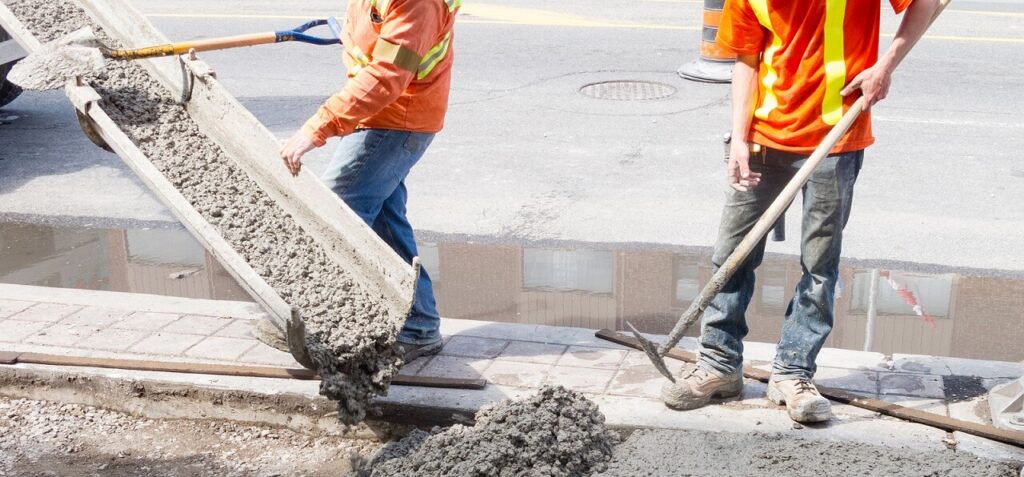 Oregon contractors pouring out cement on sidewalk